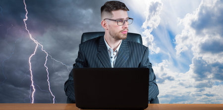 The concept of success and failure in business. A businessman with a laptop against a clear and gray...