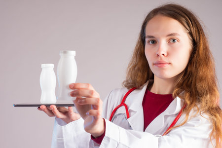 Probiotics and prebiotics. The concept of healthy eating. The doctor demonstrates bottles of healthy...