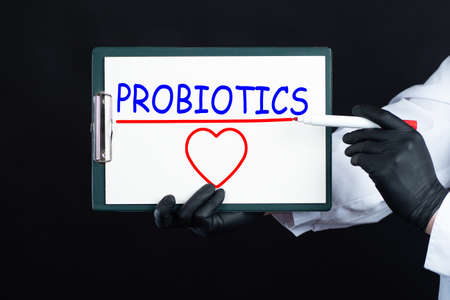 The word probiotics and heart. Useful bacteria for health. The concept of probiotics on a black background. Probiotics and prebiotics. Beneficial micro-organisms. Prevention of dysbacteriosis.の写真素材