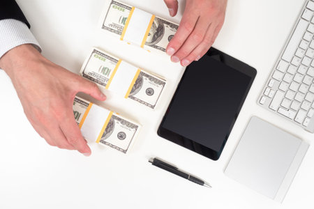 Investments in virtual projects. Investing money on the Internet. Computer, tablet and money on the...