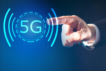 The person puts his finger to the 5G logo. Using a high-speed network. 5g concept on a blue...