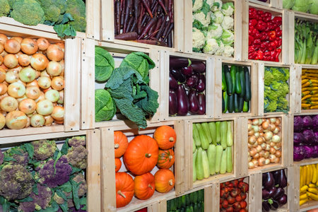 Crates of fresh vegetables. A wall of wooden boxes with vegetables. Harvest of fresh vegetables. The...