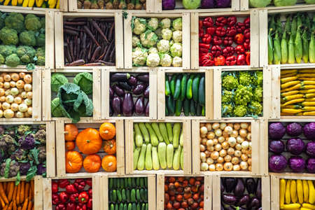 Multi-colored vegetables. Boxes of fresh vegetables on top. A variety of vegetables in wooden boxes. Agricultural crop. Farm products. Sale of fresh products. Vegetarian food.の写真素材