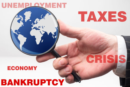 Global economic crisis. A person studies the state of the world economy. Unemployment, high taxes,...