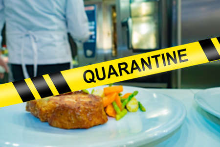 Cafe against the background of the restrictive tape and the inscription Quarantine. The restaurant is closed for coronavirus quarantine. Termination of the work of public catering enterprises.の写真素材