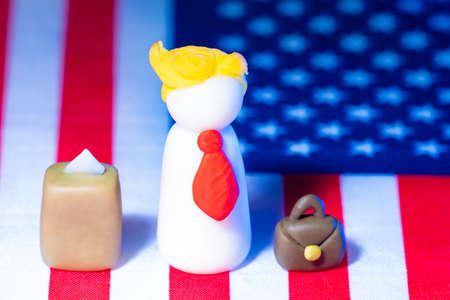 Concept of the USA Presidential election. Symbolic figure of  on the background of the flag of America.  near the ballot box. American president. American policy.の写真素材