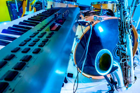 Musical instruments. Performances of musicians. Drum kit. Saxophone. Electronic piano. Preparing for the concert. Music background.の写真素材