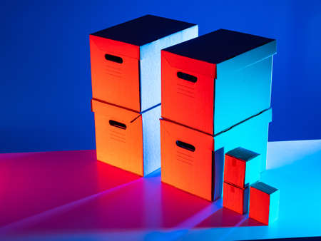 A set of cardboard boxes in a bright multicolored light. Delivery of goods. Shipping materials. Product packaging. Home delivery of orders. Courier service.の写真素材