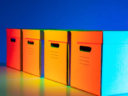 Boxes with handles and lids. Boxes for storing documents. Paper archive. Four boxes on a bright blue background. Containers for storing documents.の写真素材