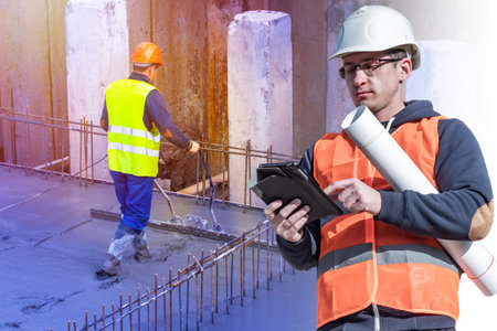 Engineer in an orange vest and hard hat on the background of the Foundation of the building. The...