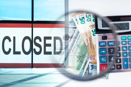 Word Closed against the background of money and calculator. Termination of business activity....
