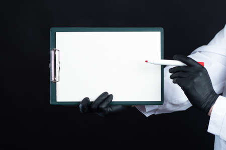 Training of doctors. Doctor with a sign and a marker in his hands. Professional development of doctors. Lecture at the medical University. Space for text.の写真素材