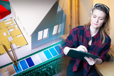 Interior designer. Architecture. A girl makes a design project for a new house. Designer against the...