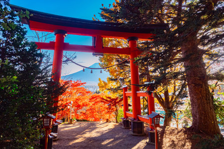 Autumn Japan. Red gate of the temple. Kawaguchi Asama Temple. Red torii on the background of autumn...