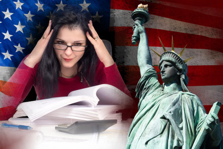 A girl studies documents against the background of the American flag and the statue of liberty....