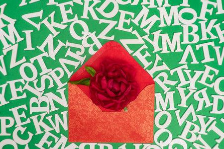 The envelope with a bright flower is surrounded by letters. Holiday greetings. Sending a greeting...
