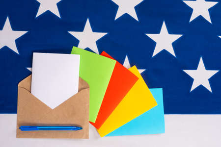 Multicolored letters on the background of the stars of the American flag. Correspondence with Americans. US post. Writing paper with space for text on the background of the flag of the USA.の写真素材