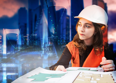 Architect girl on the background of the evening city. Work on a construction project. Convenient...