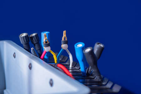Connectors on a blue background. Wired connection. Technical concept. Network switch and cables. Data Center Concept.の写真素材