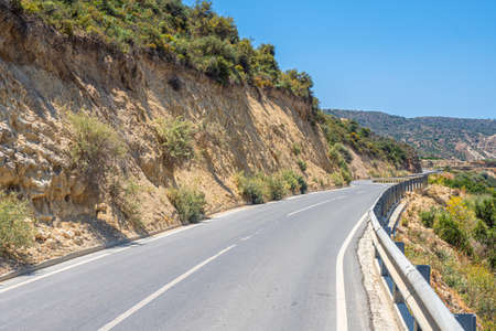 The mountain road is empty. The road runs between the rocks. Travel to the Mediterranean coast. Travel by car. A trip to beautiful places on a summer day.の写真素材