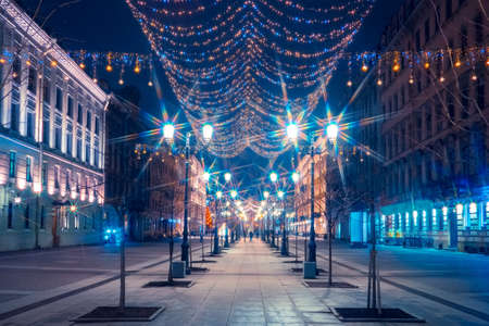 Festive illumination of city streets. Sparkling garlands in the city. Christmas in Russia. The city streets are decorated for the New year. Festive evening. Shining garlands.の写真素材