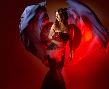 The girl with the VAPE. A Vaper woman holds an e-cigarette in her hands and looks away. A girl with...