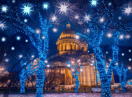 Christmas in Russia. New year in Saint-Petersburg. Festive Petersburg. St. Isaac Cathedral on the background of Christmas lights. Winter evening in Russia. Festive decorations near Isaac Cathedral.の写真素材