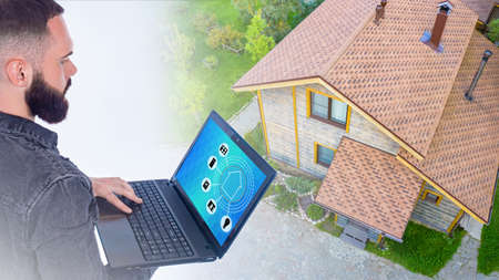 A man manages household appliances in the house through a special app. Connecting to the Smart home system. The concept of smart things. Modern technologies.の写真素材