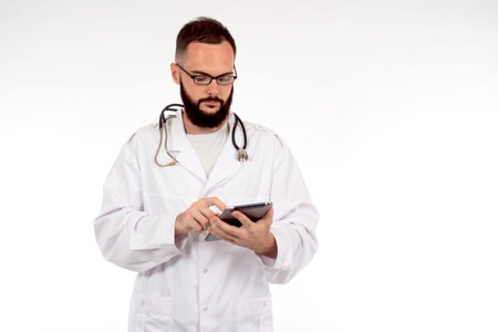 Male doctor with stethoscope and tablet. The doctor consults the patient online. Remote medical...