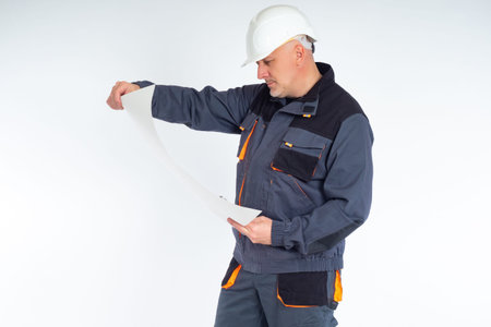 Master examines the papers. Builder holds an architectural drawing plan on paper. Profession of...