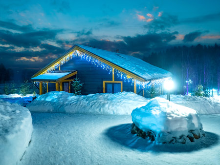 Christmas night. The cottage is decorated for Christmas. House with festive illumination on the...