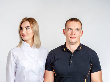 A man and a woman look in different directions. Portrait of a man and woman on a white background....