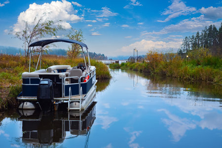 The boat is on the shore of the lake. Water trips. Motor boat against the beautiful sky. Boat...