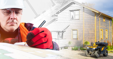 The work of an architect. The creation of the project of a new home. Civil engineer on the background of a built building. Planning and construction of cottages.の写真素材