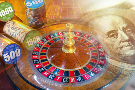 Dollar bill and casino chips on the background of roulette. Games of chance. Cash game. Cash bets in the hope of winning. Place bets in a casino.の写真素材