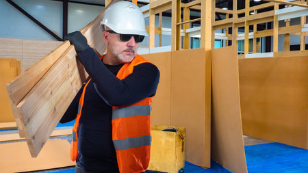 Construction of partitions in the building. The man with the boards. Zoning of space. The large room...