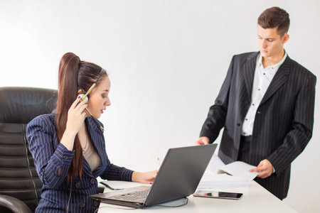 A man and a woman in business suits. Office work. Colleagues do their job. Employees don't pay...