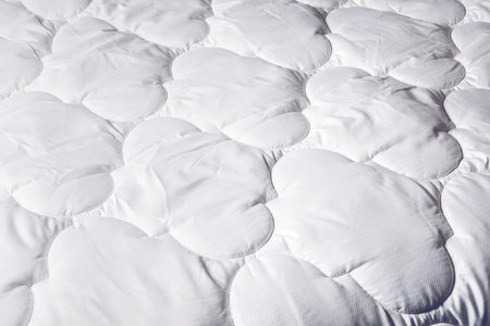 Sleep products. White blanket. Soft feather bed. Mattress for the bed. Soft background made of home...
