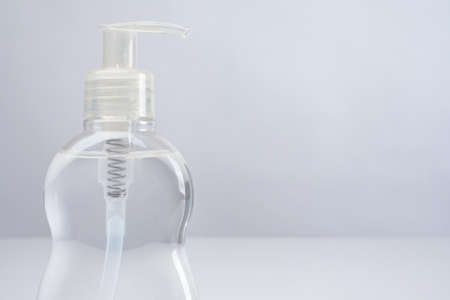 Bottle of disinfectant close-up. Sanitizer on a light background. Liquid for eliminating viruses and bacteria. Place for the label. The fight against the disease during the quarantine.の写真素材