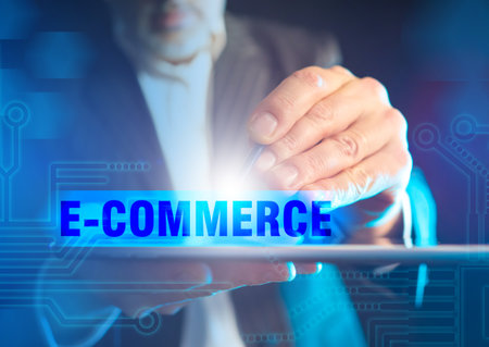 E-Commerce concept in blue. A man makes an order in an online store. Purchases via mobile apps. E-Commerce logo.の写真素材