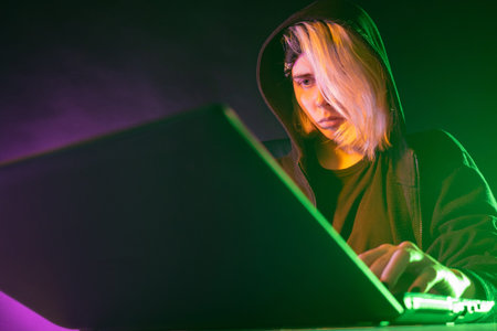 Blogger at his laptop. A teenager with blond hair is playing a computer game. The concept of...