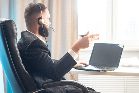 Service Desk agent. Reference service. A man consults clients. A man in headphones with a microphone...