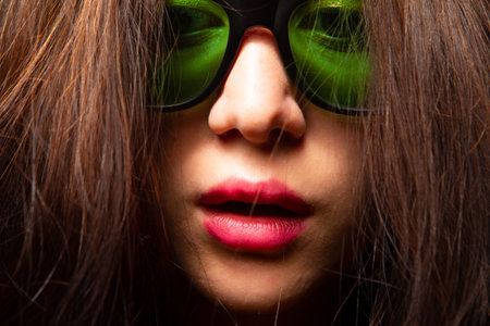 The girl face in sunglasses. A woman with her hair down. Female face with open mouth close-up....