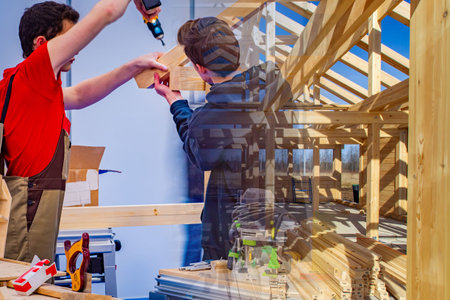 Two men work with a tree. Concept - preparation of parts of house for the citizens. Workshop for the...