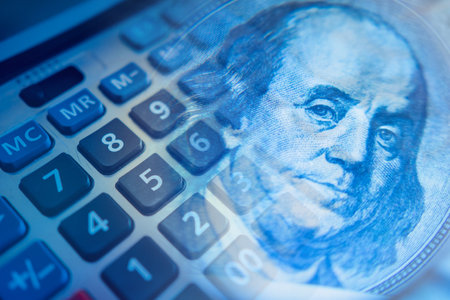 Podschet money. Calculator keys next to franklin portrait. Concept - accounting services. Fragment of a calculator close-up. Concept - personal finance. Financial analysis. Analysis personal expensesのeditorial素材