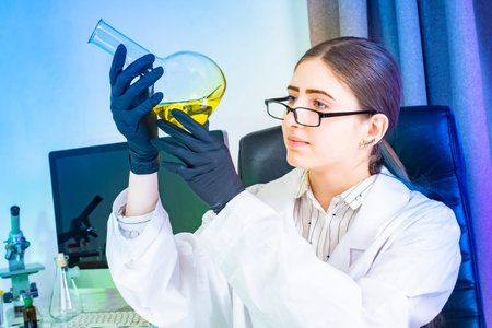 Lab technician examines a liquid in a test tube. Concept - work in a medical laboratory. A medical...