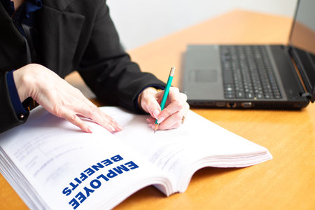 Inscription unemployment benefit on documents. Concept - a person fills out an application....