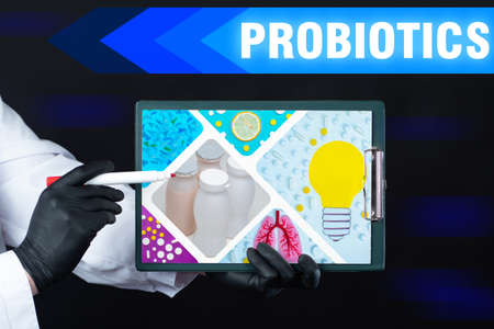 Probiotics for immunity. Doctor holds a presentation with image probiotics. Human lung treatment. Use of probiotics to support human lungs. Concept - discoveries in field of beneficial microorganismsの写真素材
