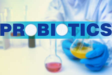 Manufacture of probiotics. Logo of probiotics next to a medical laboratory assistant. Doctor creates probiotics in laboratory. Microbiologist makes bifidobacteria. Creation of dietary supplements.の写真素材