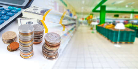 Retail. Concept - income retail areas of the company. Concept - reduction of supermarket revenues. Coins as a symbol of small incomes. Counting grocery store profits. Losses of retailers.の写真素材